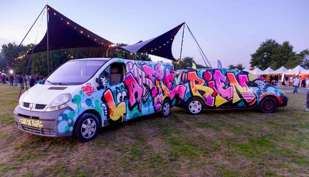 Le van graffé de L'Art de Rien garé sur le site du festival Van graffé aux couleurs de L'Art de Rien garé sur le site, repérer les lieux avant la soirée avec son chien d'assistance