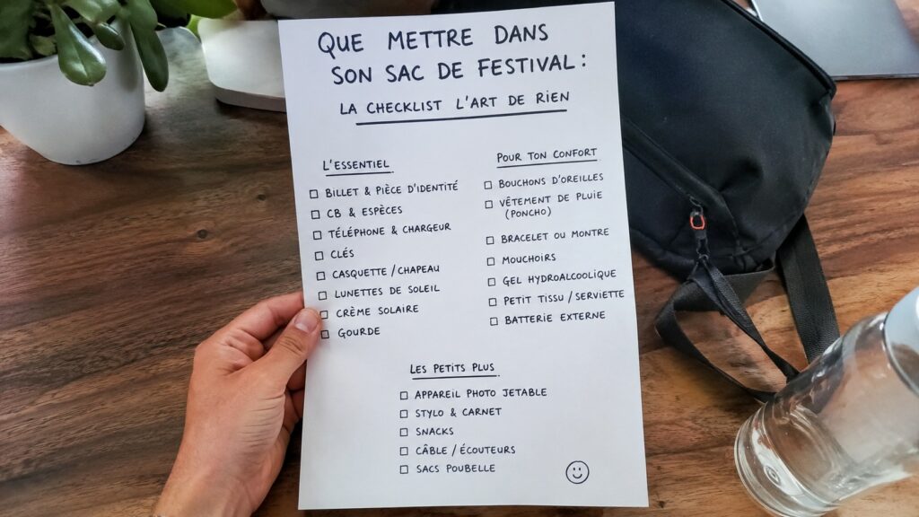 Sac à dos noir ouvert avec checklist complète des indispensables pour un festival, comprenant gourde, batterie externe, bouchons d'oreilles, lunettes de soleil et accessoires de confort, photographié en lumière naturelle avec un Panasonic Lumix S5 dans un style documentaire réaliste.